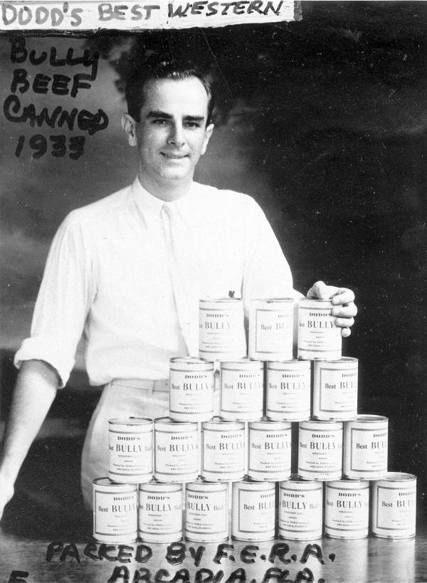 Man displaying cans of Bully Beef