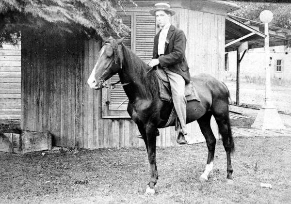 Man sitting atop horse in front of Mr. Stock's Barbershop - Hawthorne, Florida