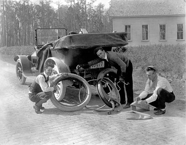 Men changing tire.