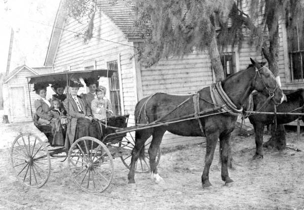 Women with girls in buggy.
