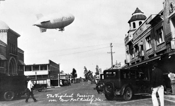 The Goodyear blimp Vigilant over street