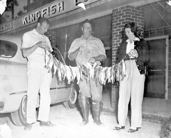 People holding fish.