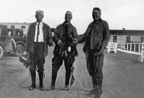 Three men with quail