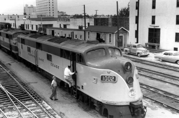 Engineer Emory Whidden climbing to cab of locomotive #1002.