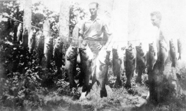 R. H. Williford shows his large catch of fish.