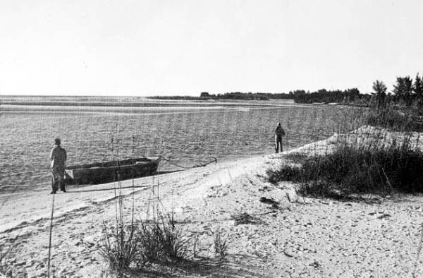 Men anchored at beach - Sanibel Island, Florida.
