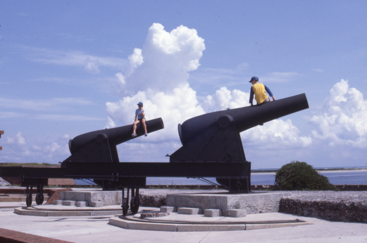 Kids sitting atop cannons at Fort Clinch - Fernandina Beach, Florida