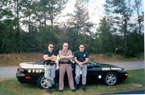 Troopers stand in front of a Chevy Camaro especially equipped for law enforcement