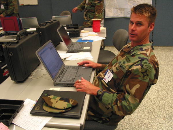 National guardsman Major Tad Warfel in cubicle set-up at the Hurricane Charley command post in the Publix shopping plaza - Punta Gorda, Florida