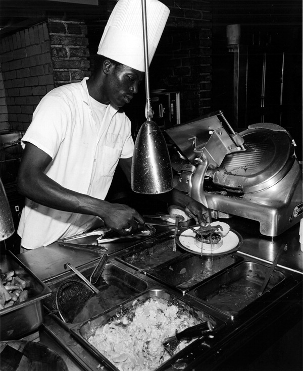 Unidentified cook preparing a burger - Fort Lauderdale, Florida.