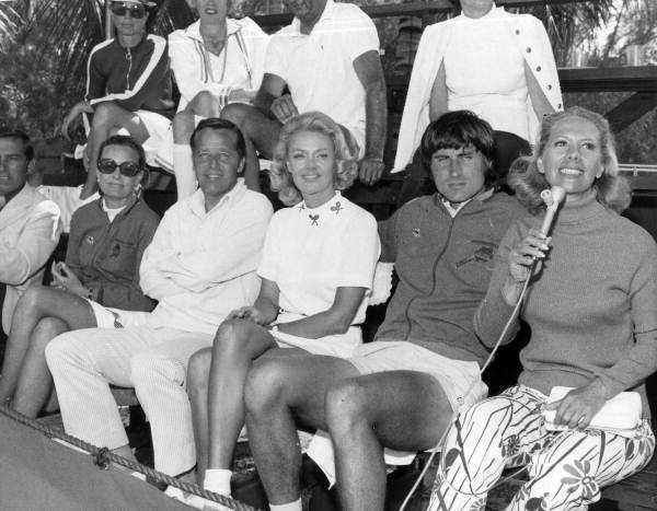 Dinah Shore (right) sitting with tennis player Ilie Nastase and friends at an unidentified event - Fort Lauderdale, Florida