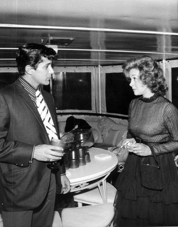 Motion picture actress Susan Hayward chatting with an unidentified man - Fort Lauderdale, Florida.