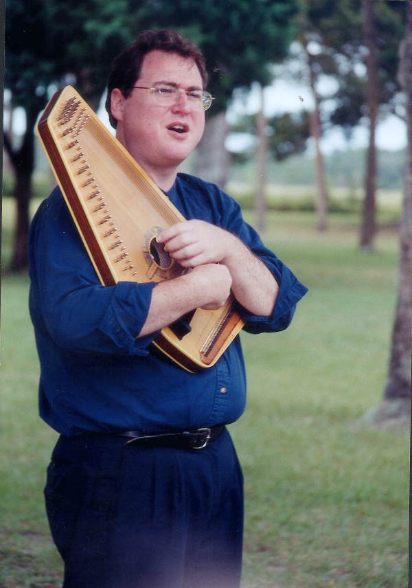 Jon Kay plays an autoharp at Kingsley Plantation National Historic Site - Jacksonville, Florida .