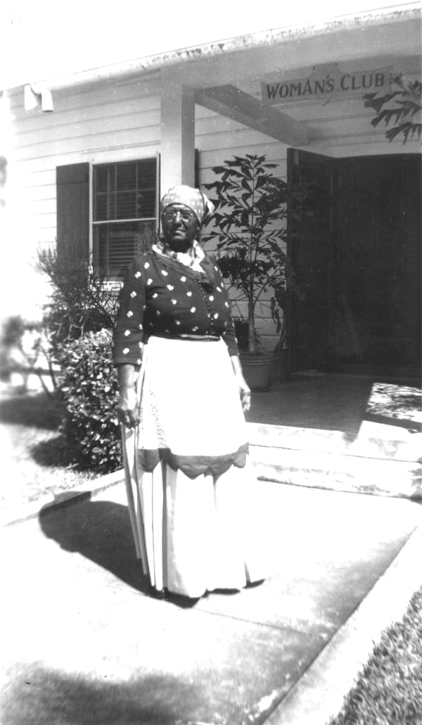 Portrait of an unidentified African American woman standing outside the local Woman's Club - Lake Worth, Florida.
