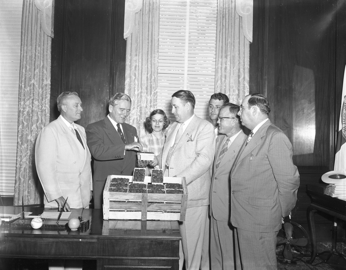 Governor Fuller Warren accepting strawberries from Florida growers
