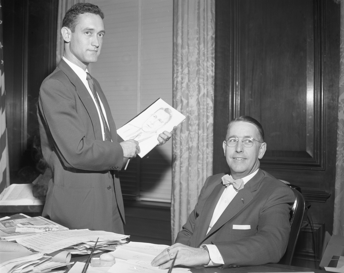 Governor Charley Johns with an artist sketching his portrait.