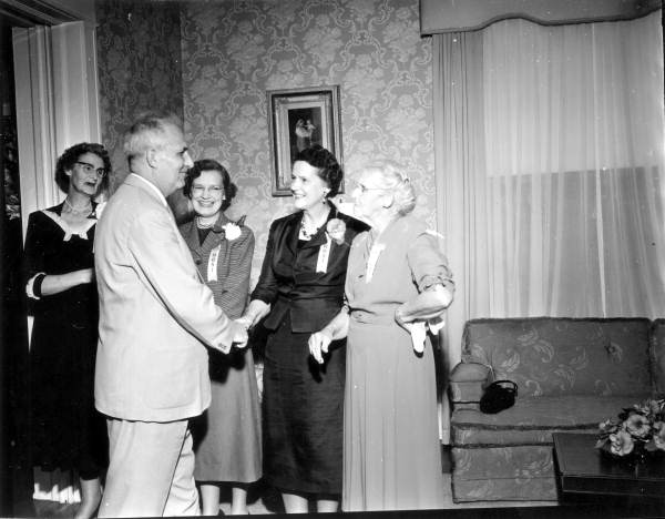 Hostesses greeting a guest at Governor Collins' inaugural reception at the Mansion - Tallahassee, Florida.