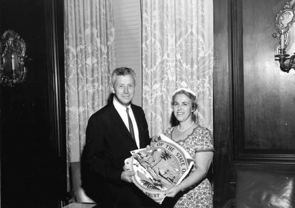 Governor Collins presenting state flag to Mrs. Louis E. Goldman of Coral Gables - Tallahassee, Florida.