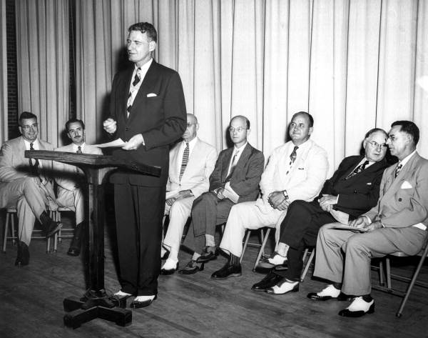 Governor Millard F. Caldwell giving a lecture from a lectern