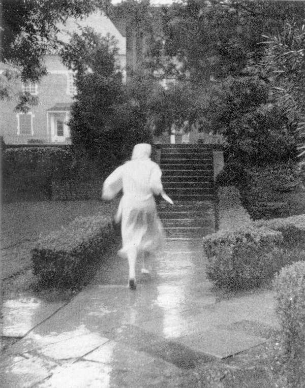 An FSU student scurrying in autumn rain - Tallahassee, Florida.