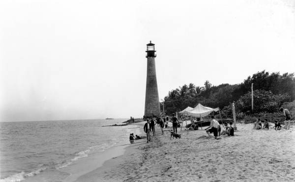 People on the beach by the Cape Florida Lighthouse