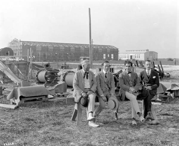 Small group of men posing, with Miami Studios construction site in the background - Hialeah, Florida