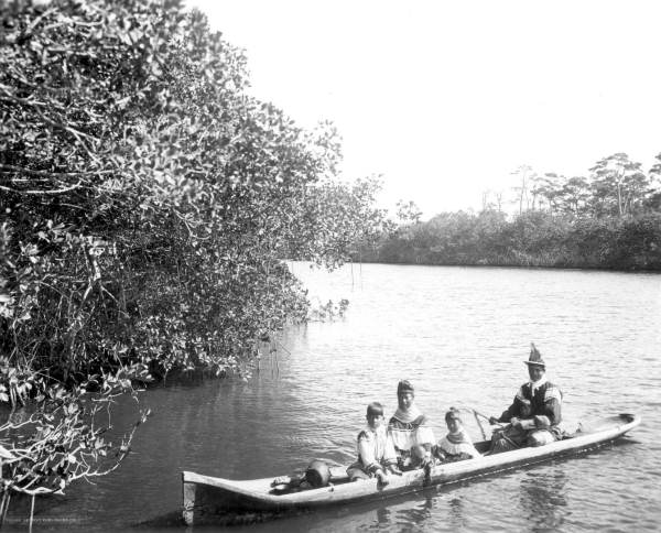 Seminole Indians in a canoe on the Miami River - Miami, Florida.