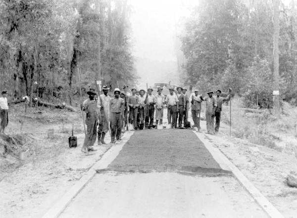 Road crew posing while laying down asphalt for a new road - Polk County, Florida