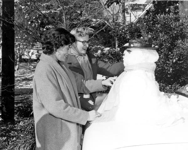 Florida State University students having fun building a snowman - Tallahassee, Florida.