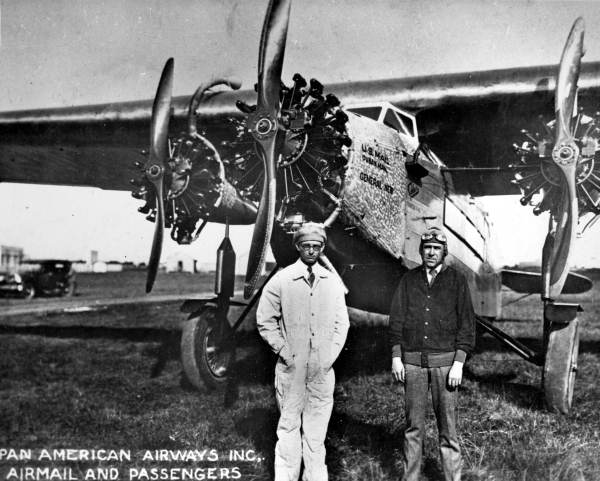 Men posed in front of a tri-motor Fokker airplane - Key West, Florida