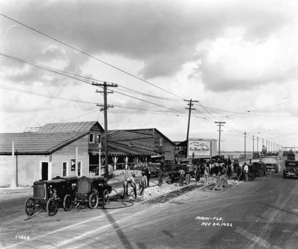 Workers on the entrance to the county causeway - Miami, Florida.