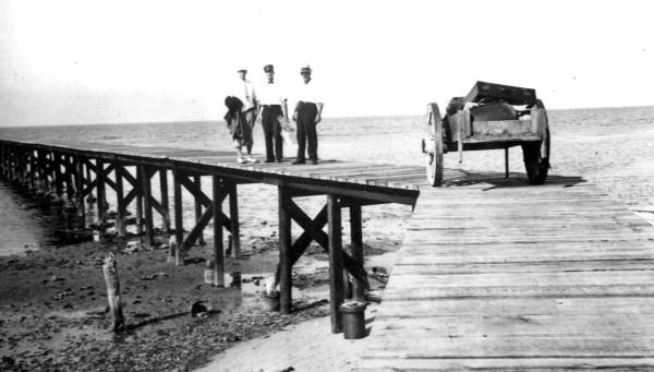 Lighthouse keeper Walter Roberts with men on pier - Saint George Island, Florida