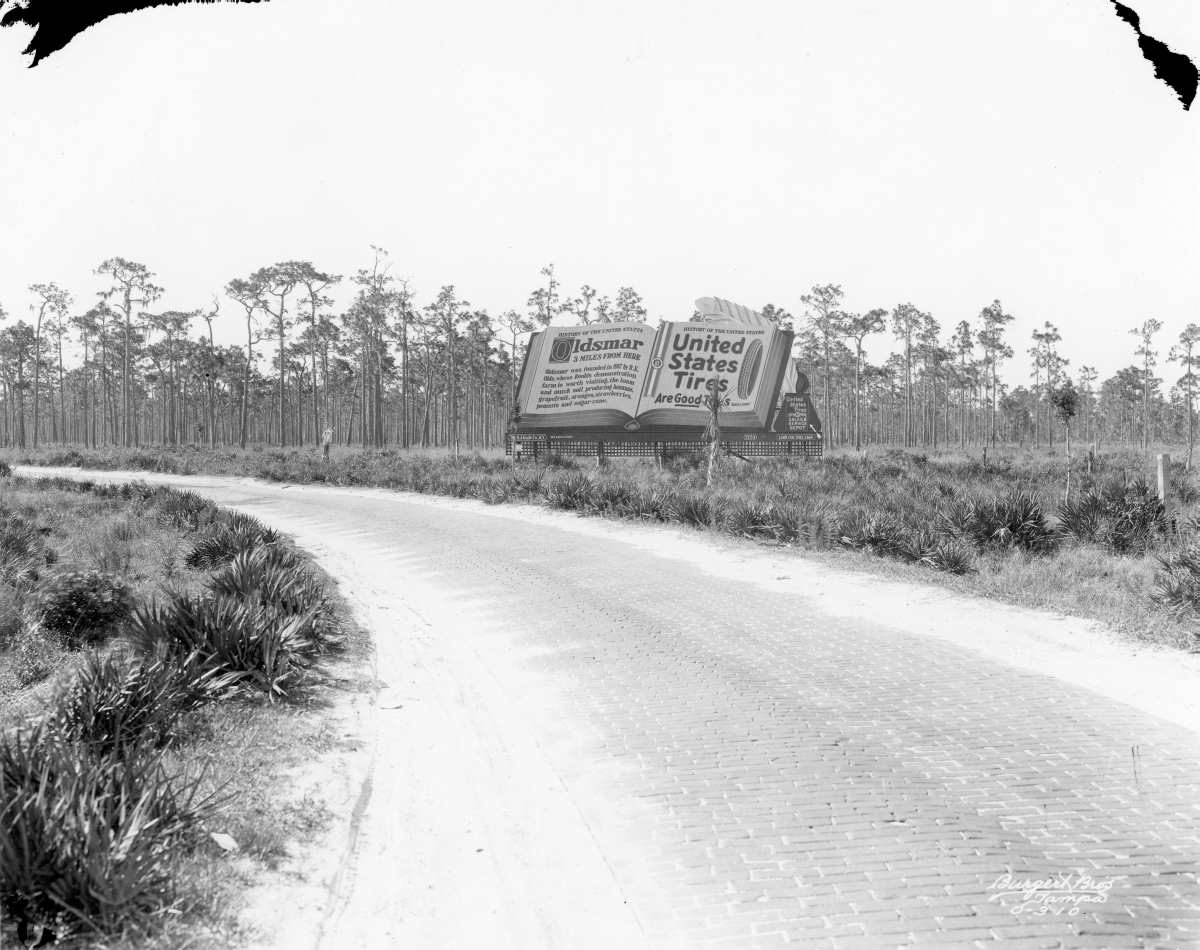 Looking down an early "Highway" towards a billboard for United States Tires - Oldsmar, Florida.