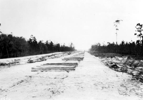 Ties unloaded for railroad construction from Perry to Monticello