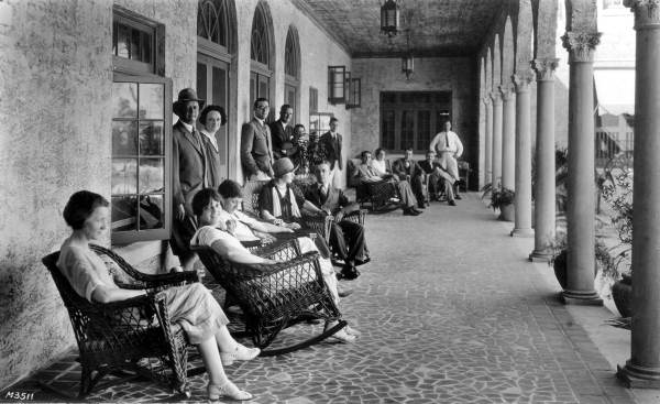 People seated on porch at the Casa Loma hotel - Coral Gables, Florida