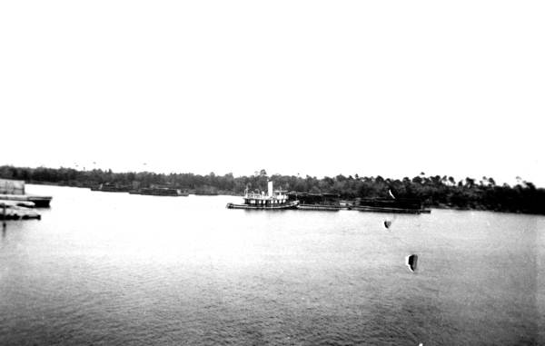 Bagdad Land and Lumber Company tugboat with barges of lumber
