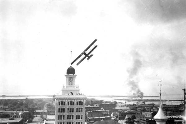 Biplane flying around Tampa's City Hall - Tampa, Florida