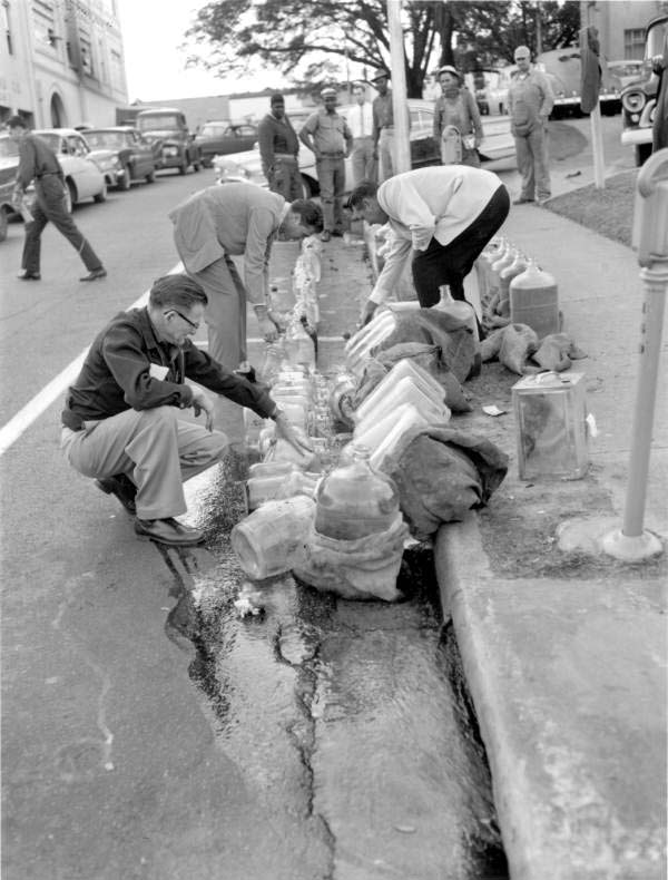 Confiscated moonshine being emptied into the sewer - Tallahassee, Florida