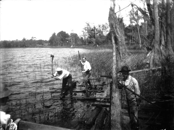 Lumbermen forming a log raft on Lake Santa Fe - Alachua County, Florida