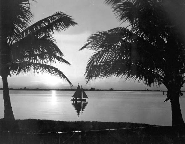 Silhouette of sailboat in Biscayne Bay - Miami, Florida.