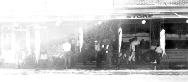 Front of Williams Drug Store, with tarpon fishes hanging from the awning - Crystal River, Florida