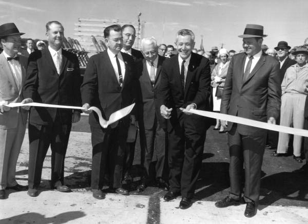 Governor Collins cutting ribbon during Pensacola Bay Bridge dedication ceremony.
