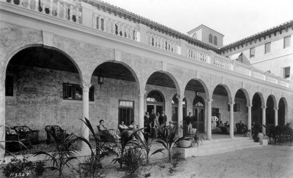 People seated on the porch at the Casa Loma hotel - Coral Gables, Florida