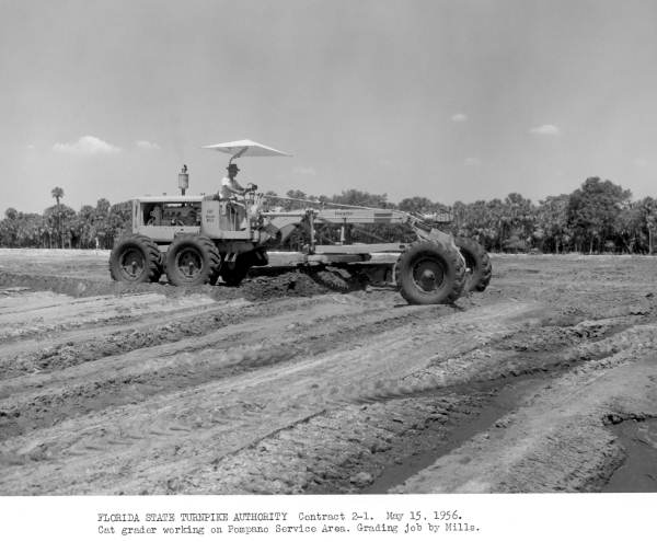 Road grader at work preparing ground for the Pompano Beach "service plaza," on the Sunshine State Parkway (Florida Turnpike) - Pompano Beach Region, Florida.