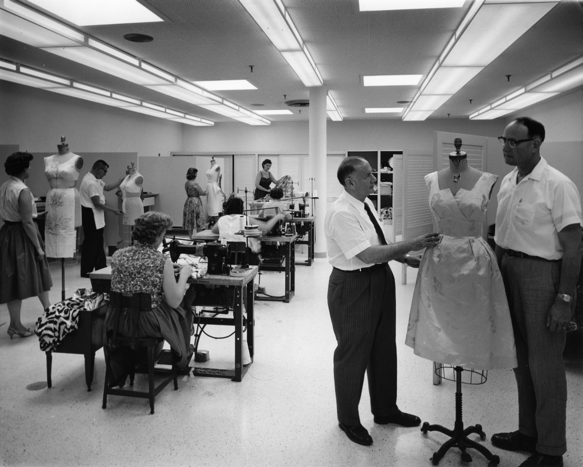 Alex Schneidman and Luther Powell, his associate, inspect a sample dress