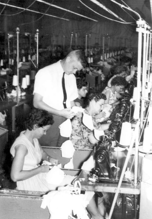 Warner's plant manager checking on work of assembly line - Marianna, Florida