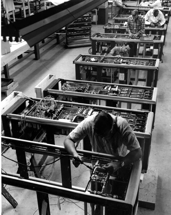 Milgo Electronic Corp. technicians working on computer production line - Miami, Florida