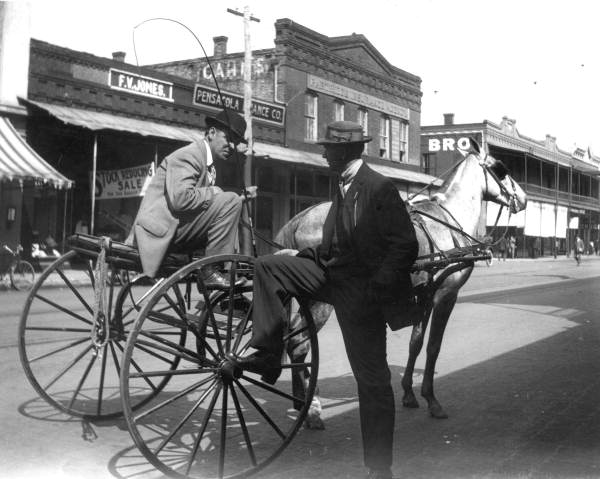 Men talking on Palafox Street while horse waits - Pensacola, Florida.