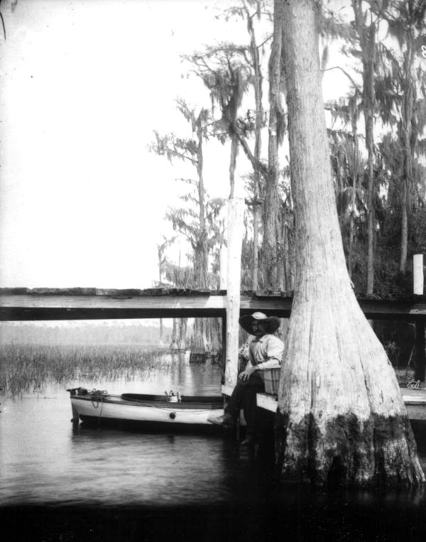 A man sitting on dock at Santa Fe Lake - Melrose, Florida
