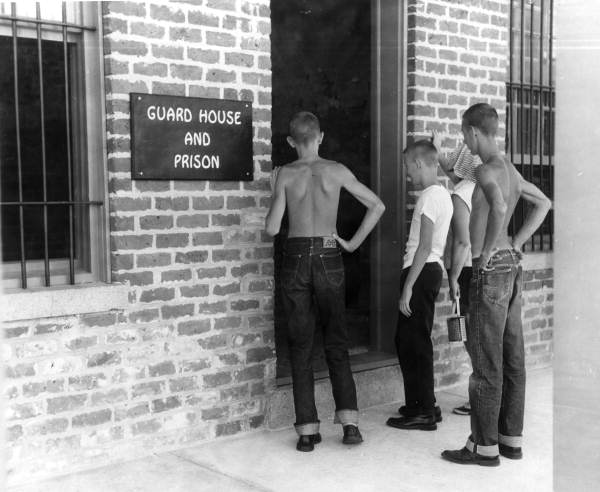 Visitors by a guard house/prison museum building at Fort Clinch State Park